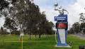 Image displays the front grassy area and the sign to the Dandenong Stadium