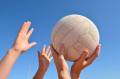 Netball being held by two people in the air