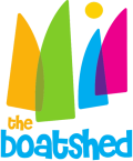 Colorful logo of "the boatshed" featuring abstract sail shapes and a sun, with vibrant shades of green, blue, pink, and yellow.